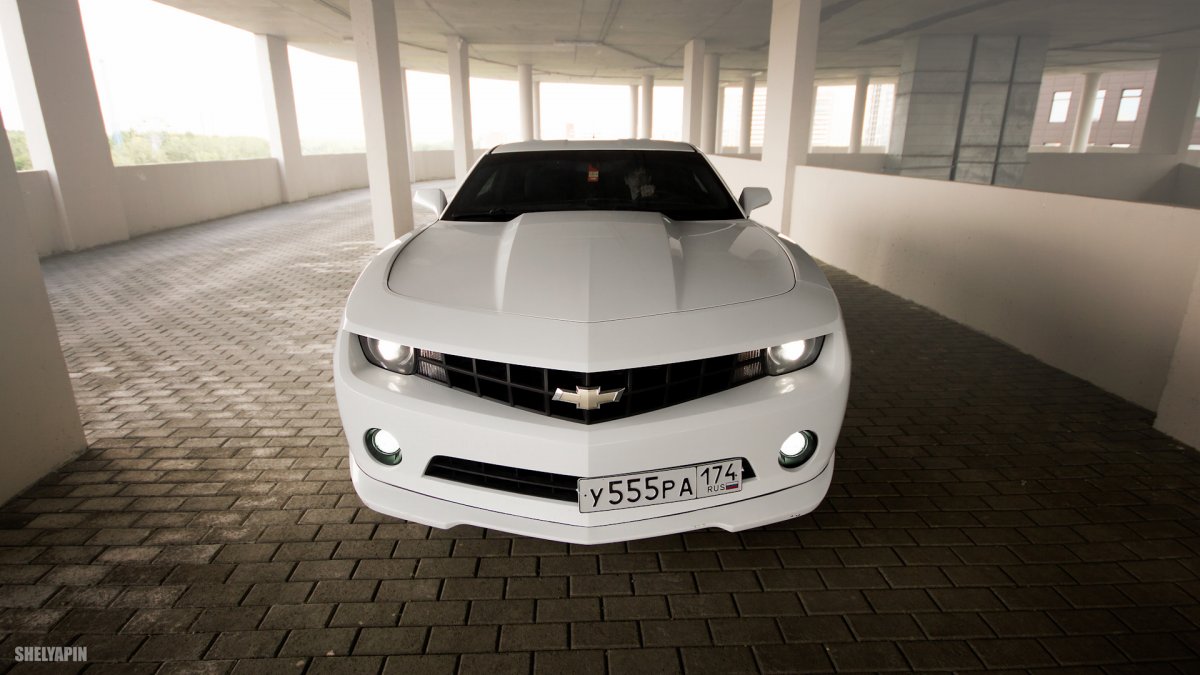 Белая машина среди черных